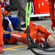 The mechanic on pit lane after being hit by the car.